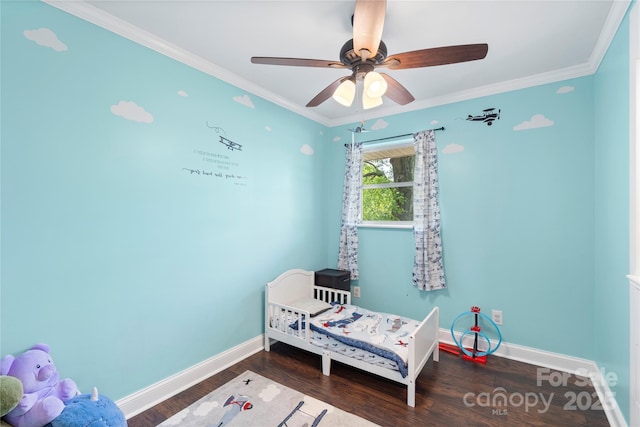 bedroom featuring ceiling fan, baseboards, crown molding, and wood finished floors