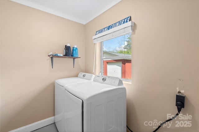 clothes washing area featuring separate washer and dryer, baseboards, and laundry area
