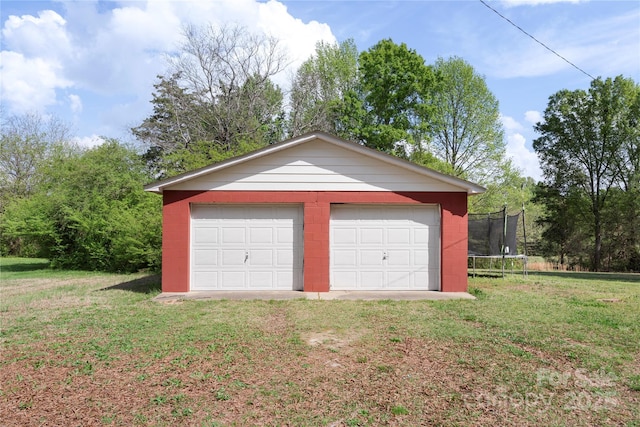 detached garage with a trampoline