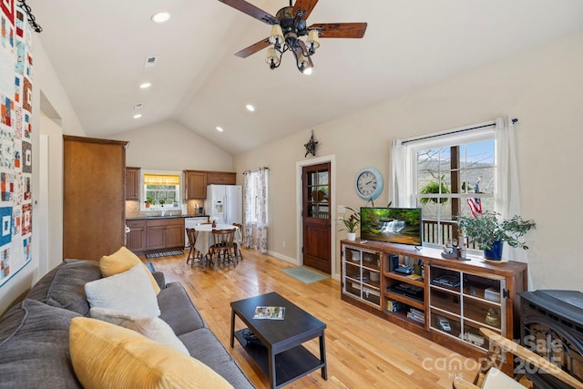 50 Honey Mountain Ln, Lake Toxaway, NC 28747 - living area featuring lofted ceiling, light wood-style floors, a ceiling fan, healthy amount of natural light, and recessed lighting