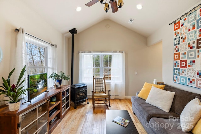 50 Honey Mountain Ln, Lake Toxaway, NC 28747 - living room with a wood stove, a ceiling fan, plenty of natural light, light wood-style floors, and vaulted ceiling