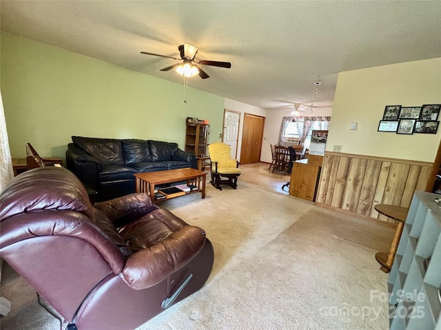 138 Friendship Dr, Ellenboro, NC 28040 - carpeted living room with wooden walls, a ceiling fan, wainscoting, and a textured ceiling