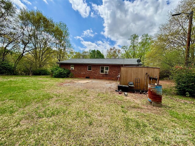138 Friendship Dr, Ellenboro, NC 28040 - rear view of house with a lawn