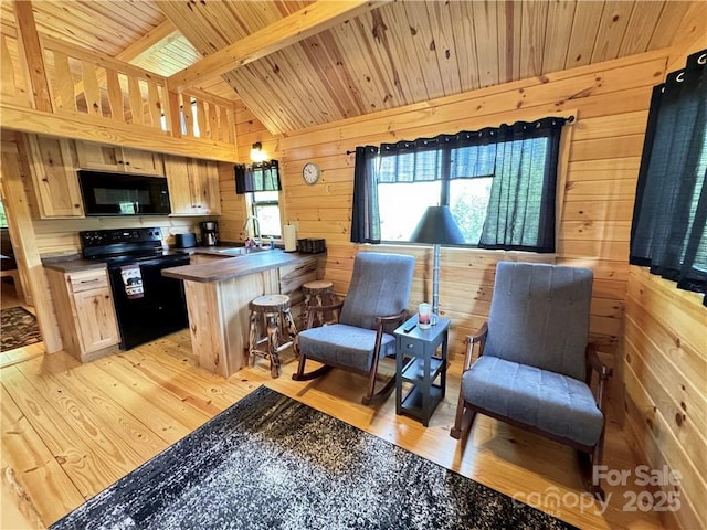 kitchen featuring black appliances, wood ceiling, wood walls, dark countertops, and a peninsula