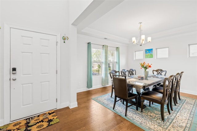 12305 Stinson Ct, Charlotte, NC 28277 - dining area with baseboards, an inviting chandelier, ornamental molding, a raised ceiling, and wood finished floors
