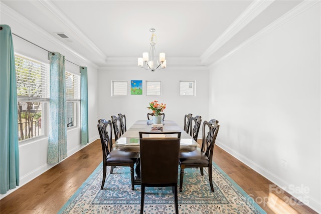 12305 Stinson Ct, Charlotte, NC 28277 - dining space featuring a notable chandelier, baseboards, crown molding, visible vents, and wood finished floors
