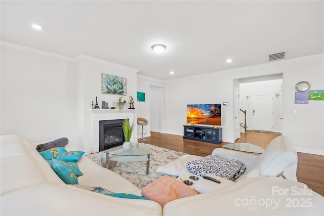 12305 Stinson Ct, Charlotte, NC 28277 - living area featuring a glass covered fireplace, recessed lighting, crown molding, visible vents, and wood finished floors
