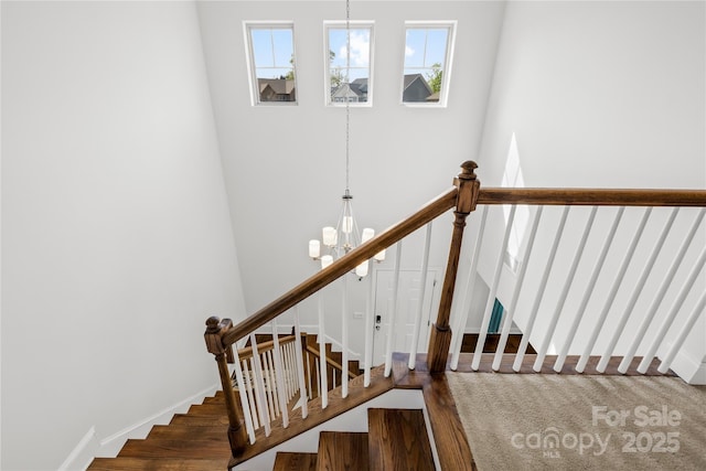 12305 Stinson Ct, Charlotte, NC 28277 - stairway with a wealth of natural light, baseboards, and an inviting chandelier