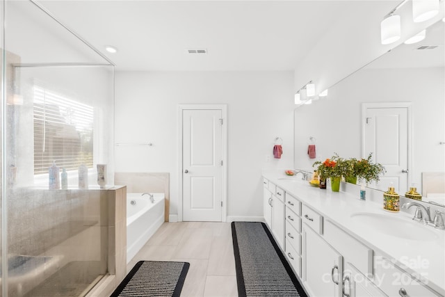12305 Stinson Ct, Charlotte, NC 28277 - bathroom featuring a garden tub, double vanity, a sink, and visible vents