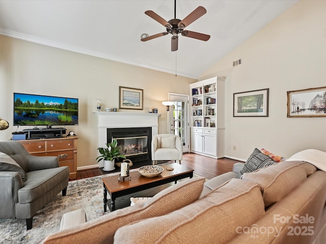 2516 Middlebridge Ln, Charlotte, NC 28270 - living area featuring a glass covered fireplace, a ceiling fan, visible vents, baseboards, and wood finished floors