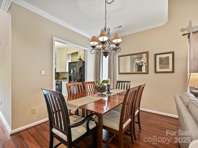 2516 Middlebridge Ln, Charlotte, NC 28270 - dining room with crown molding, dark wood finished floors, a notable chandelier, and visible vents