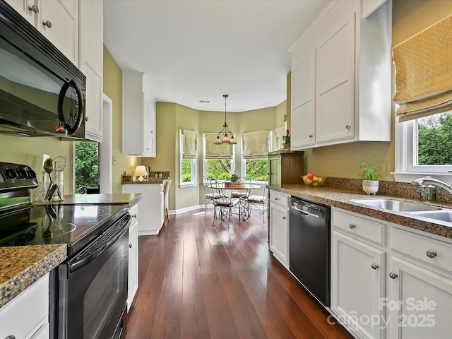 2516 Middlebridge Ln, Charlotte, NC 28270 - kitchen with white cabinets, a sink, black appliances, dark wood-style flooring, and decorative light fixtures