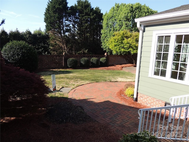 view of yard with a patio and fence