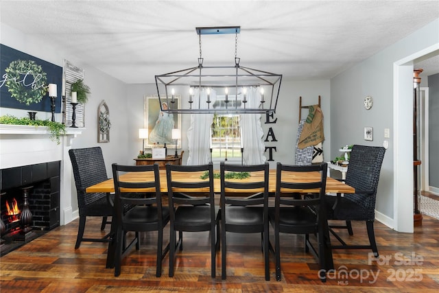 447 Henderson Rd, Chesnee, SC 29323 - dining room with baseboards, wood finished floors, a chandelier, and a tile fireplace