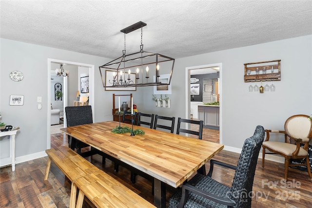 447 Henderson Rd, Chesnee, SC 29323 - dining area with baseboards, a textured ceiling, a notable chandelier, and dark wood finished floors