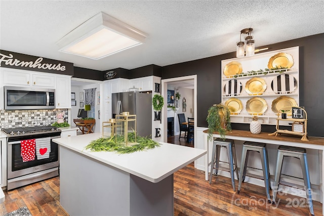 447 Henderson Rd, Chesnee, SC 29323 - kitchen with white cabinetry, light countertops, appliances with stainless steel finishes, and dark wood-type flooring