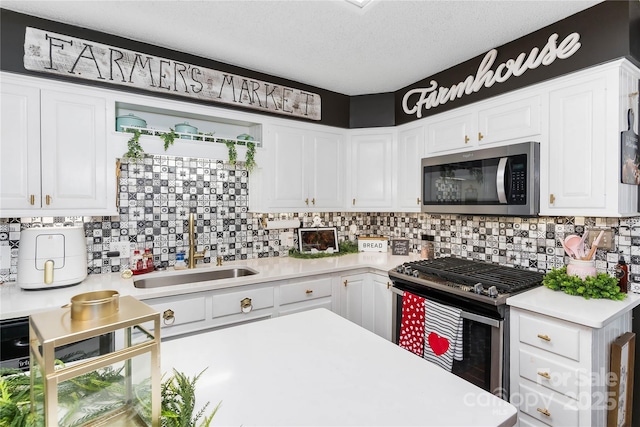 447 Henderson Rd, Chesnee, SC 29323 - kitchen featuring backsplash, appliances with stainless steel finishes, light countertops, and white cabinetry