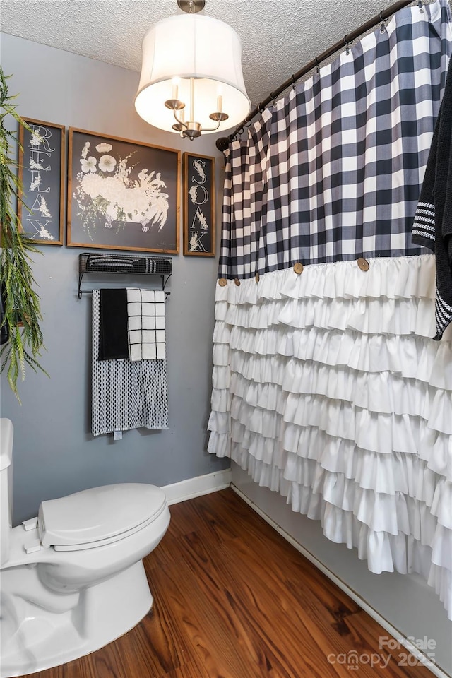 447 Henderson Rd, Chesnee, SC 29323 - full bathroom with toilet, baseboards, wood finished floors, and a textured ceiling