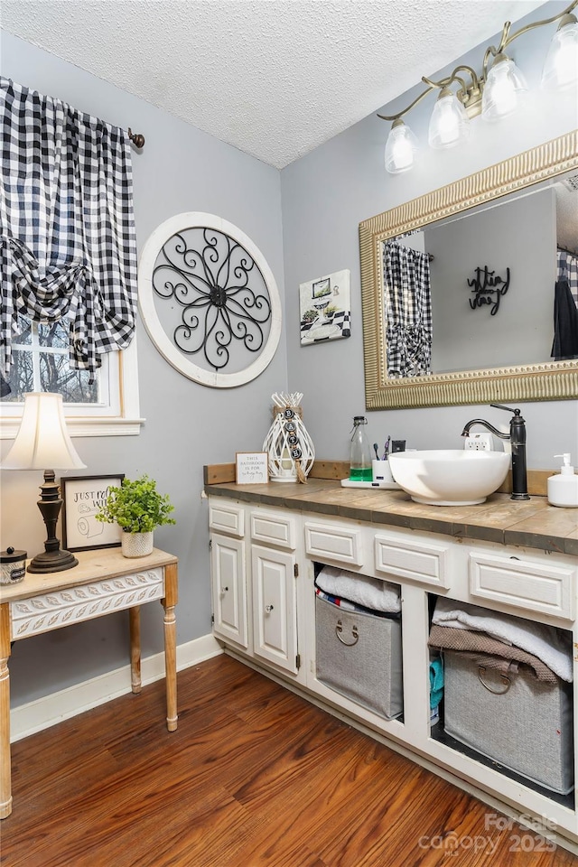447 Henderson Rd, Chesnee, SC 29323 - bathroom with a textured ceiling, wood finished floors, vanity, and baseboards