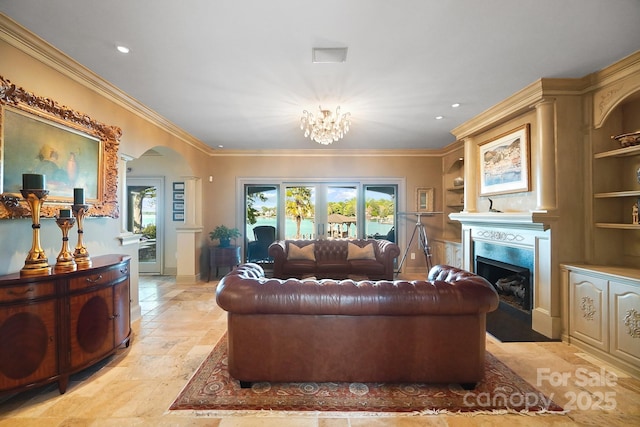 living area with arched walkways, a notable chandelier, ornamental molding, recessed lighting, and a premium fireplace