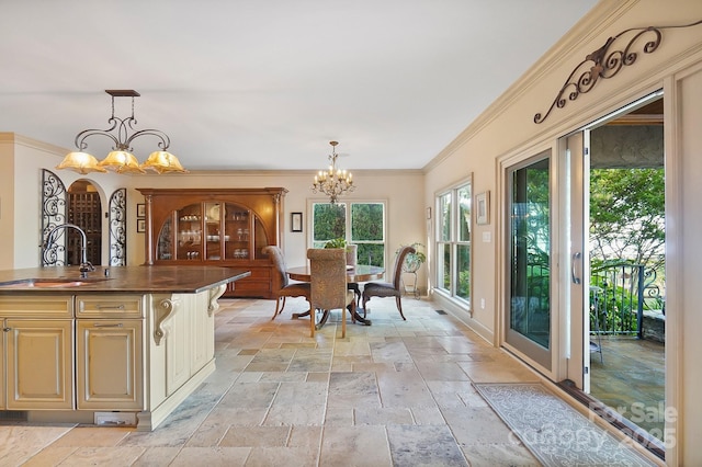 interior space featuring crown molding, a notable chandelier, and stone tile floors