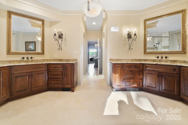 full bath with an enclosed shower, crown molding, two vanities, and tile patterned floors
