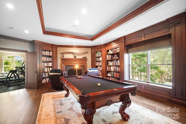 rec room with ornamental molding, billiards, wood finished floors, and built in shelves