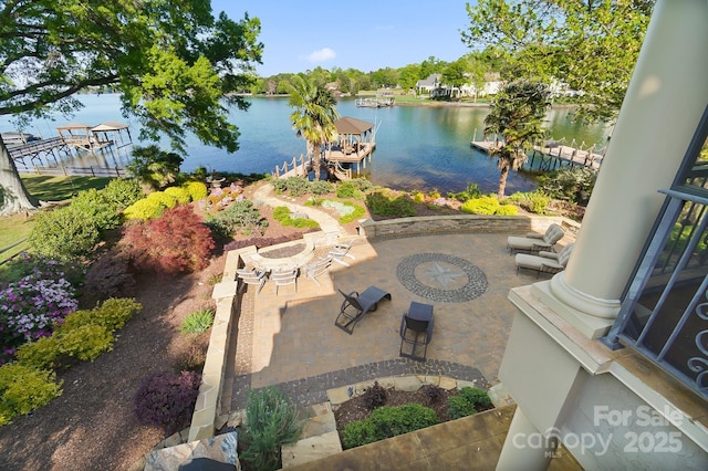 view of patio / terrace featuring a water view and a dock