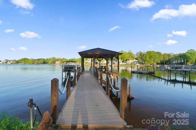 dock area with a water view and boat lift