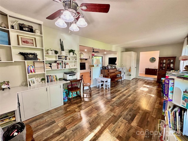 home office featuring wood finished floors and a ceiling fan