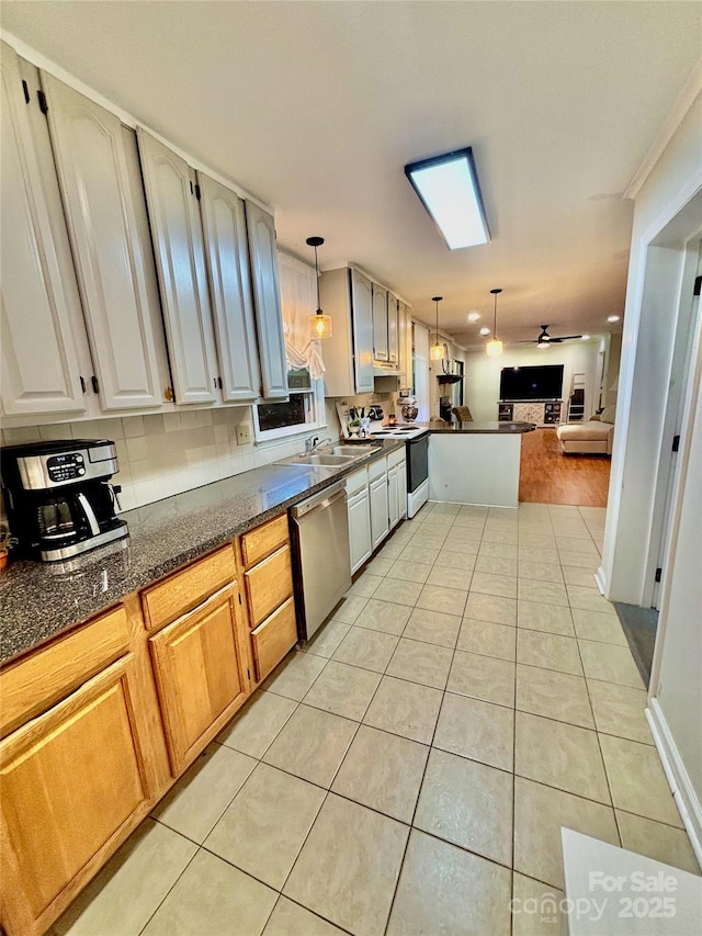 kitchen featuring open floor plan, light tile patterned floors, dark countertops, stainless steel dishwasher, and electric stove