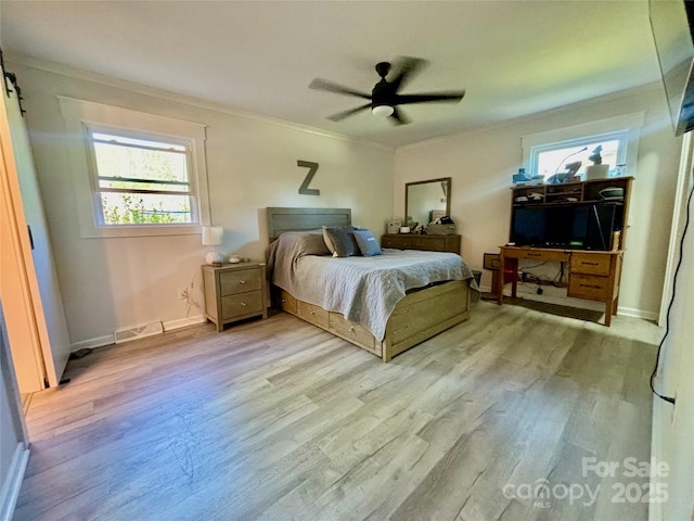 bedroom featuring baseboards, light wood-style floors, visible vents, and crown molding