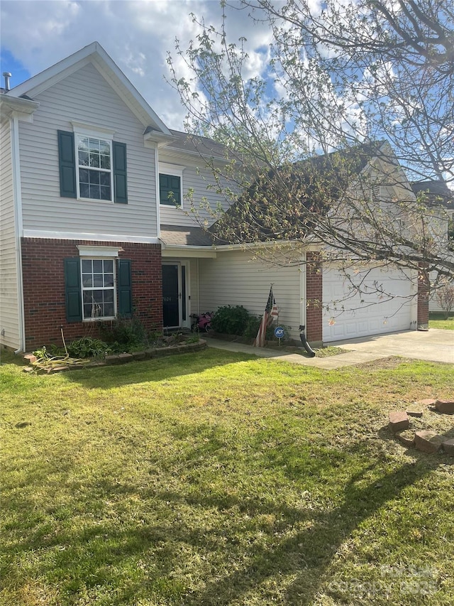 traditional home with a garage, a front yard, brick siding, and driveway