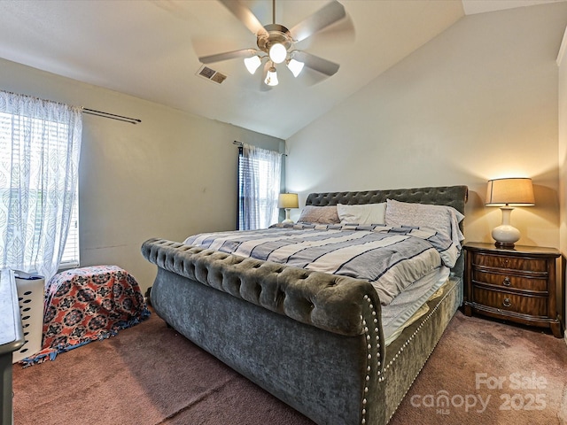 carpeted bedroom with a ceiling fan, lofted ceiling, and visible vents