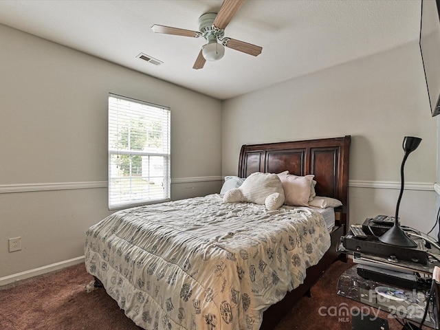 carpeted bedroom with visible vents, ceiling fan, and baseboards
