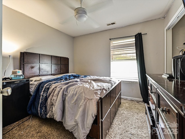 bedroom with visible vents, baseboards, and ceiling fan
