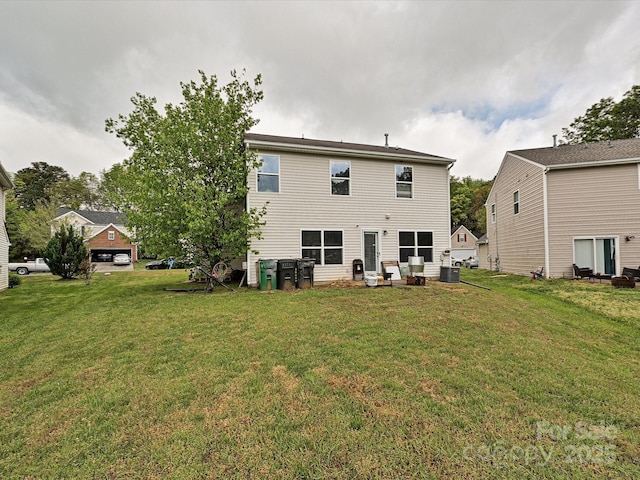 rear view of house featuring a yard and central AC unit