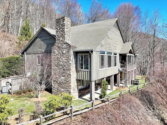 116 Dana Rd, Waynesville, NC 28786 - view of side of property with a sunroom, a chimney, board and batten siding, fence, and stairs
