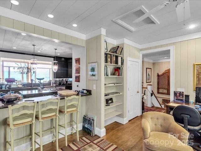 116 Dana Rd, Waynesville, NC 28786 - kitchen with recessed lighting, dark countertops, a breakfast bar area, pendant lighting, and wood finished floors