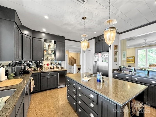 116 Dana Rd, Waynesville, NC 28786 - kitchen featuring dark stone countertops, appliances with stainless steel finishes, a kitchen island with sink, and crown molding