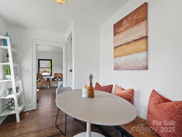 dining area featuring wood finished floors and baseboards