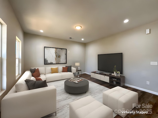 living room featuring visible vents, baseboards, recessed lighting, and wood finished floors