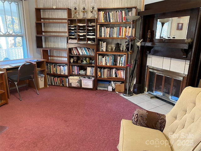 sitting room featuring tile patterned flooring and carpet