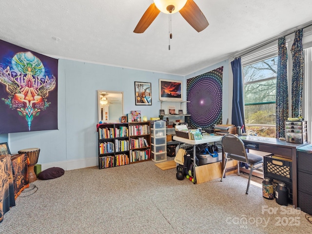 carpeted home office with baseboards, a textured ceiling, and a ceiling fan
