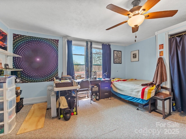 carpeted bedroom with a textured ceiling and ceiling fan