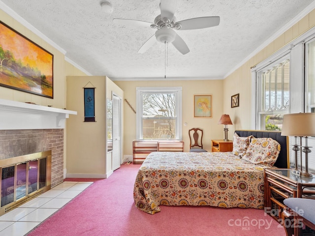 carpeted bedroom with a textured ceiling, a fireplace, and ornamental molding