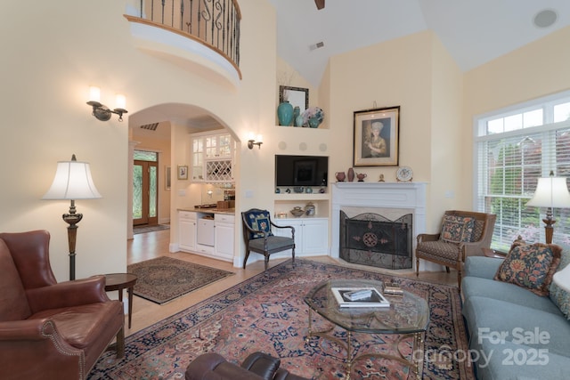 104 Hallmark Xing, Rock Hill, SC 29732 - living area with arched walkways, light wood-style floors, a fireplace, visible vents, and high vaulted ceiling