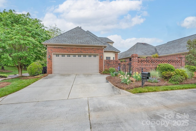 104 Hallmark Xing, Rock Hill, SC 29732 - view of front facade with a garage, a shingled roof, brick siding, concrete driveway, and fence