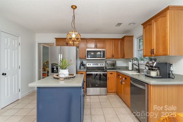 kitchen featuring stainless steel appliances, light countertops, visible vents, a sink, and light tile patterned flooring