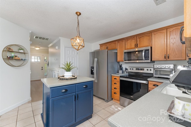 kitchen with a toaster, visible vents, light countertops, a kitchen island, and appliances with stainless steel finishes
